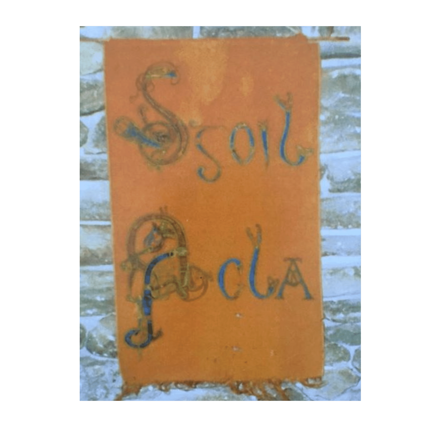 Hand-painted Scoil Acla banner in Celtic lettering hanging on a stone wall