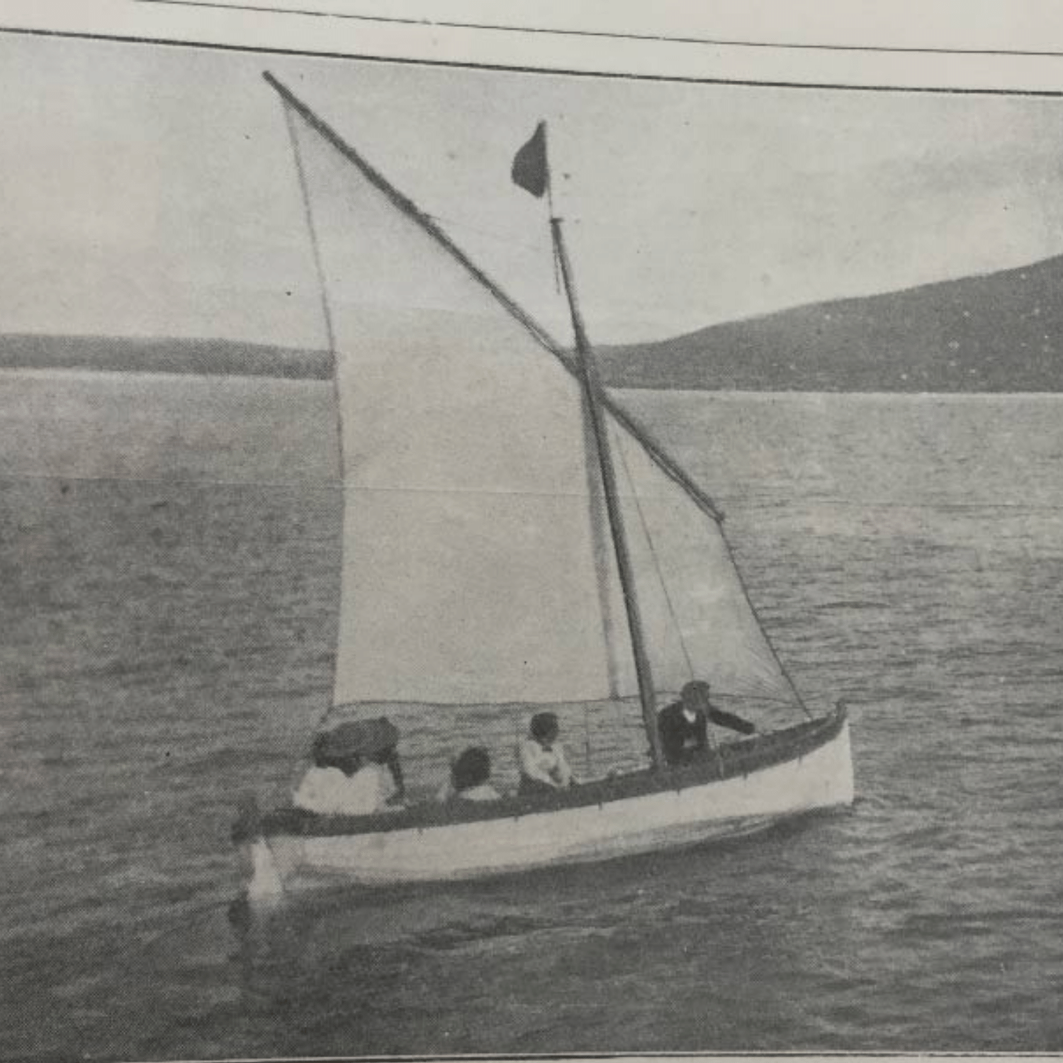 Traditional Achill sailing currach on the water with the island's hills behind