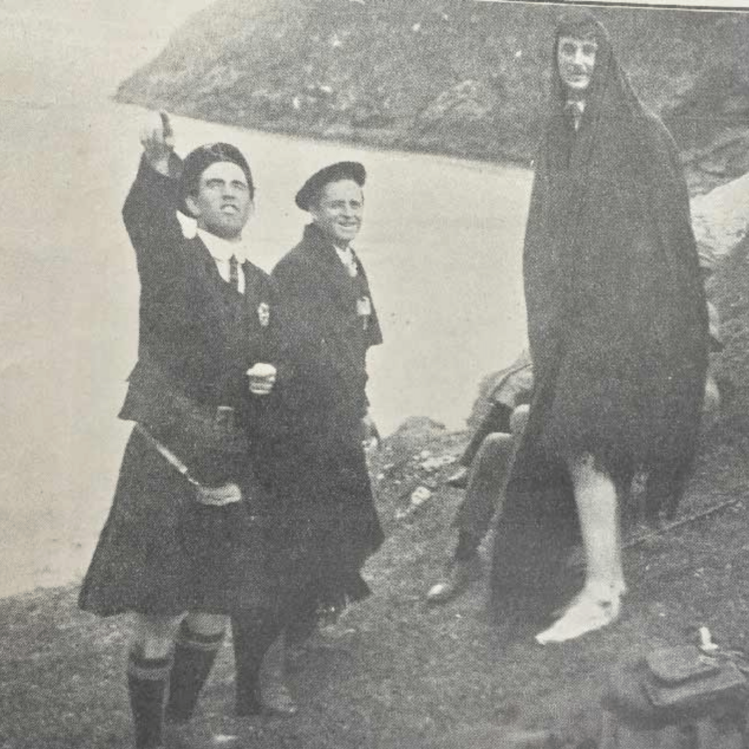 Two kilted men in traditional dress with a cloaked figure on Achill Island